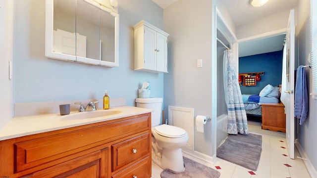 bathroom with a shower with curtain, toilet, baseboards, tile patterned flooring, and vanity