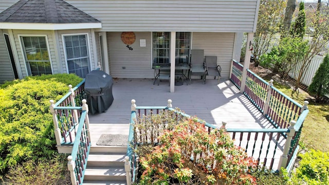 deck with grilling area and outdoor dining area