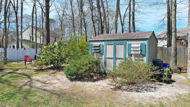 view of shed featuring fence