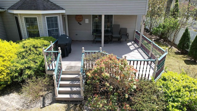 deck featuring a grill and fence