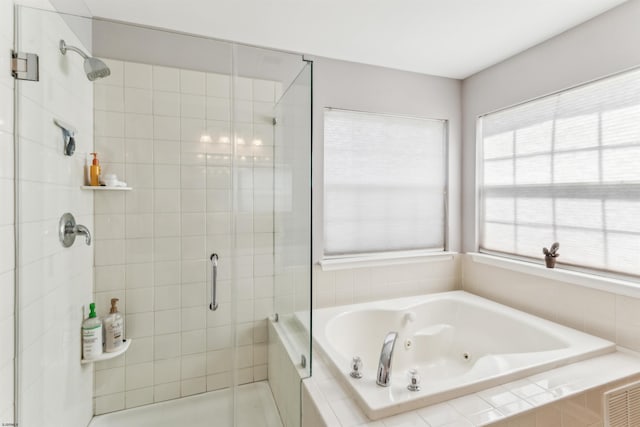 full bath featuring a tub with jets and a stall shower