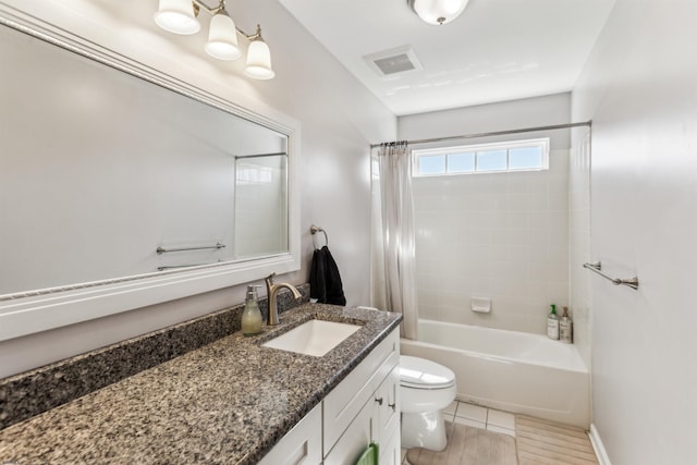 bathroom with shower / tub combo, visible vents, vanity, and toilet