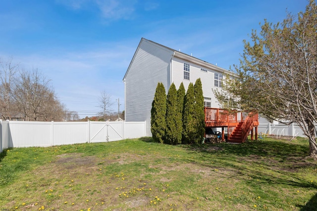 exterior space featuring a gate, a fenced backyard, stairway, and a deck