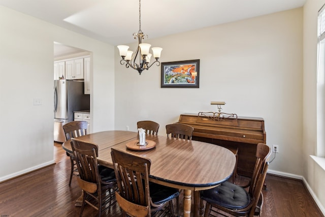 dining area with baseboards, a chandelier, and dark wood-type flooring