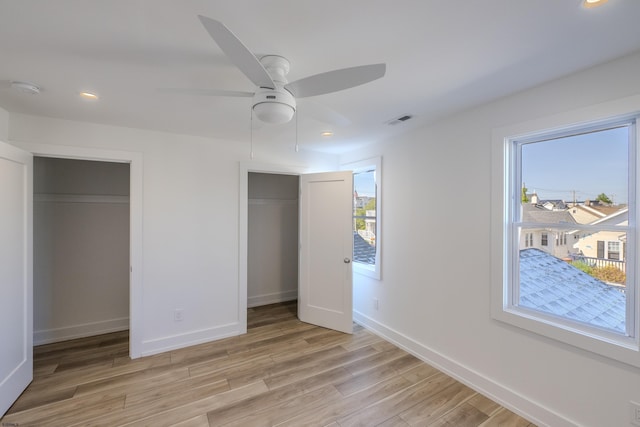 unfurnished bedroom featuring recessed lighting, light wood-style flooring, visible vents, and baseboards