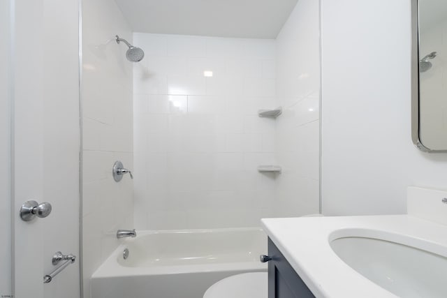 bathroom with bathing tub / shower combination, vanity, and toilet