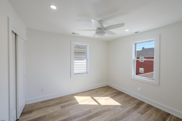 unfurnished bedroom featuring baseboards, visible vents, and light wood-style flooring