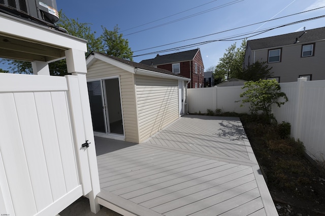 deck featuring a fenced backyard and an outbuilding