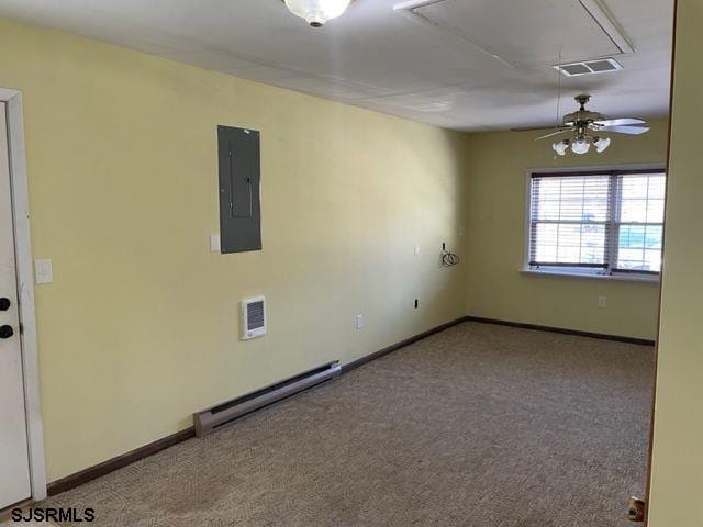 carpeted empty room featuring a baseboard heating unit, attic access, electric panel, visible vents, and a ceiling fan