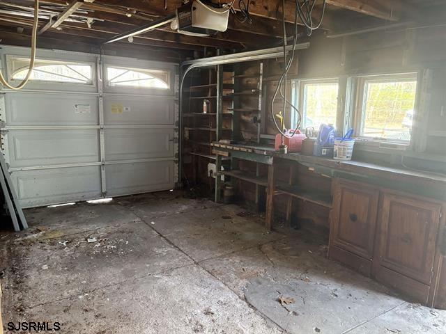 garage featuring a workshop area and a garage door opener