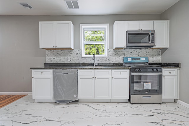 kitchen featuring marble finish floor, visible vents, a sink, baseboards, and appliances with stainless steel finishes