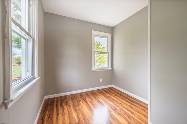empty room featuring baseboards and wood finished floors