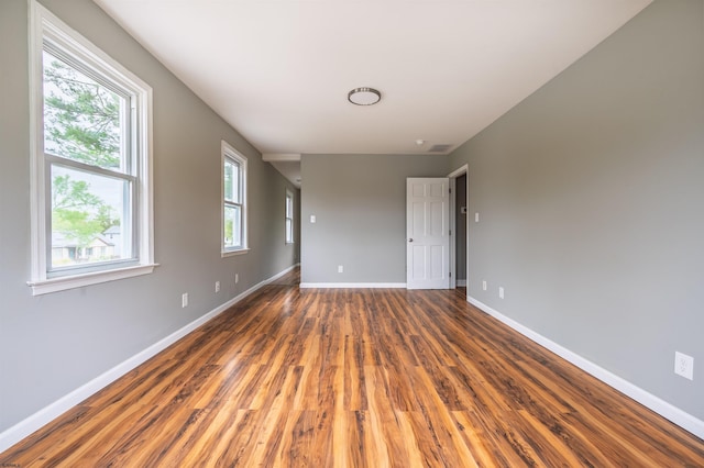 unfurnished room featuring wood finished floors and baseboards