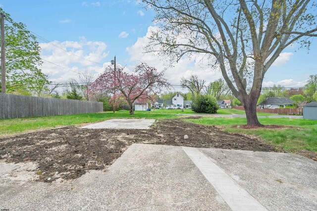 view of yard featuring a residential view and fence