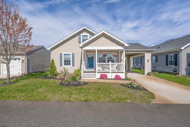 view of front of home with a front lawn, driveway, and a porch