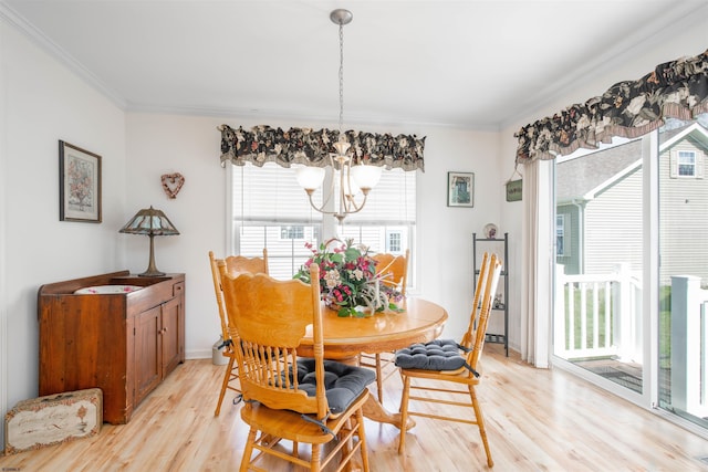 dining space with light wood finished floors, baseboards, an inviting chandelier, and crown molding