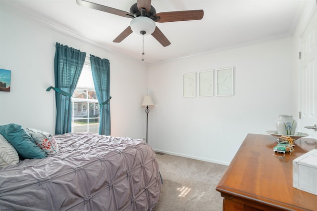 bedroom featuring ceiling fan, carpet floors, ornamental molding, and baseboards