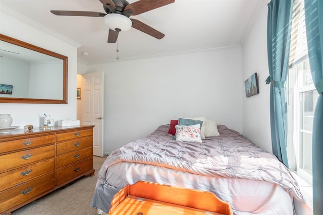 bedroom featuring a ceiling fan, light colored carpet, and crown molding