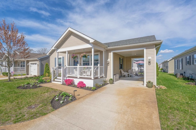 view of front of house with a shingled roof, driveway, a front lawn, and covered porch