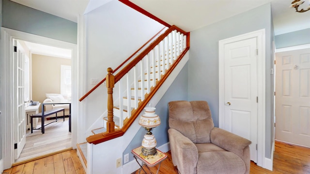 staircase with baseboards and wood-type flooring