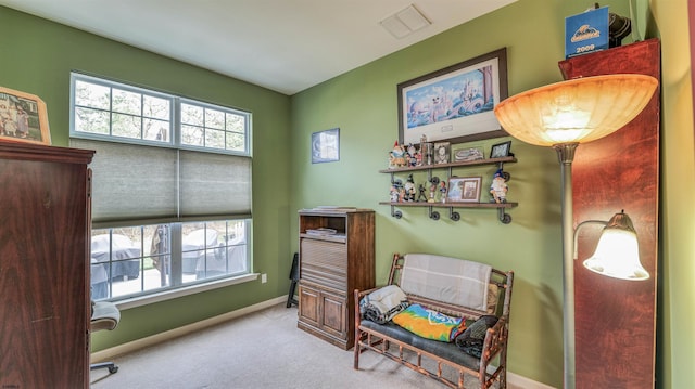sitting room featuring visible vents, baseboards, and carpet flooring