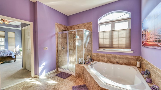 ensuite bathroom with a wealth of natural light, a garden tub, and a stall shower