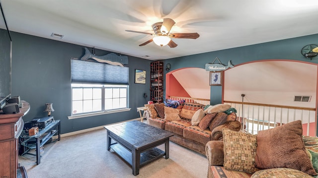 carpeted living area featuring ceiling fan, baseboards, and visible vents