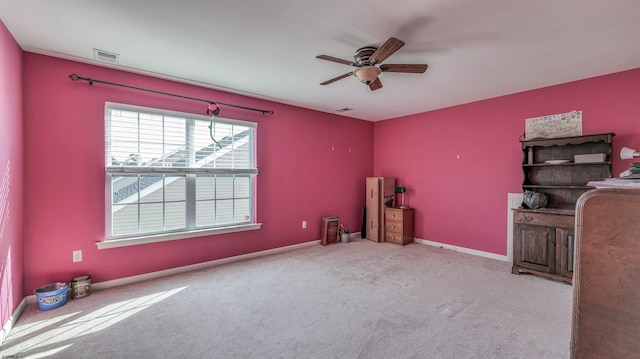misc room with a ceiling fan, carpet flooring, and visible vents