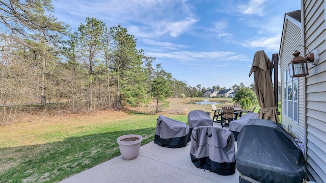 view of patio featuring a grill and a water view