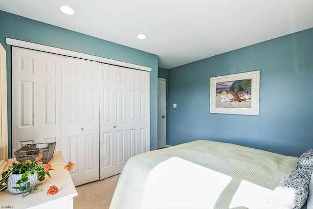 bedroom with light carpet and a closet