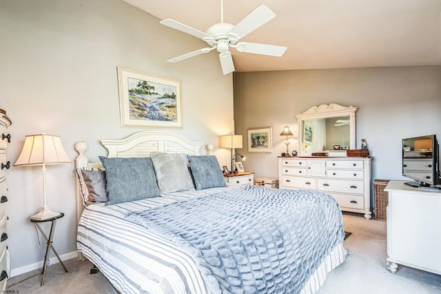 bedroom featuring baseboards, a skylight, light carpet, and ceiling fan