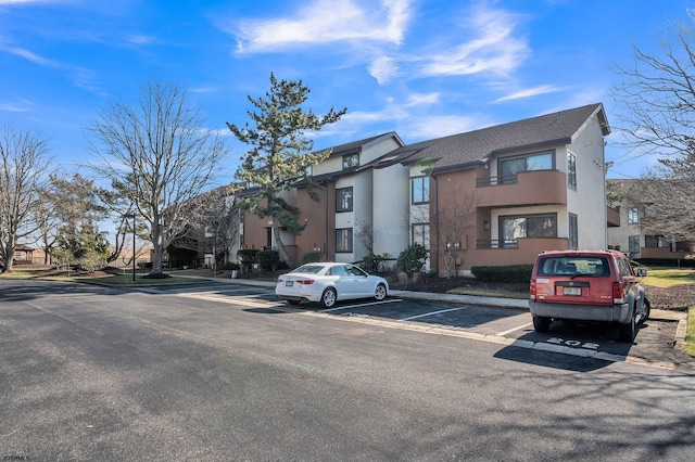 view of property with a residential view and uncovered parking