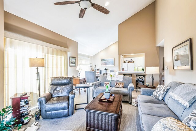 living area featuring carpet flooring, high vaulted ceiling, and ceiling fan