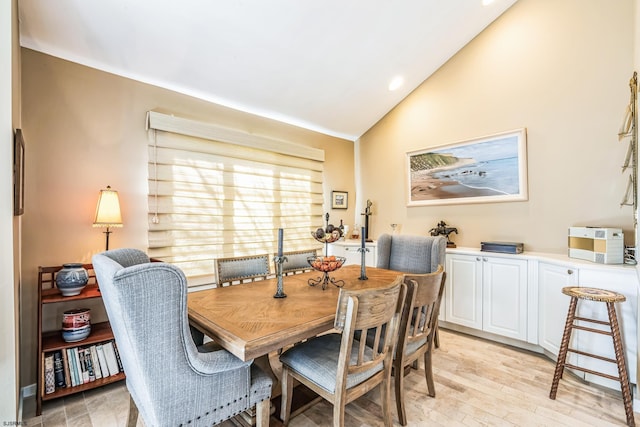 dining space featuring recessed lighting, lofted ceiling, and light wood-style floors