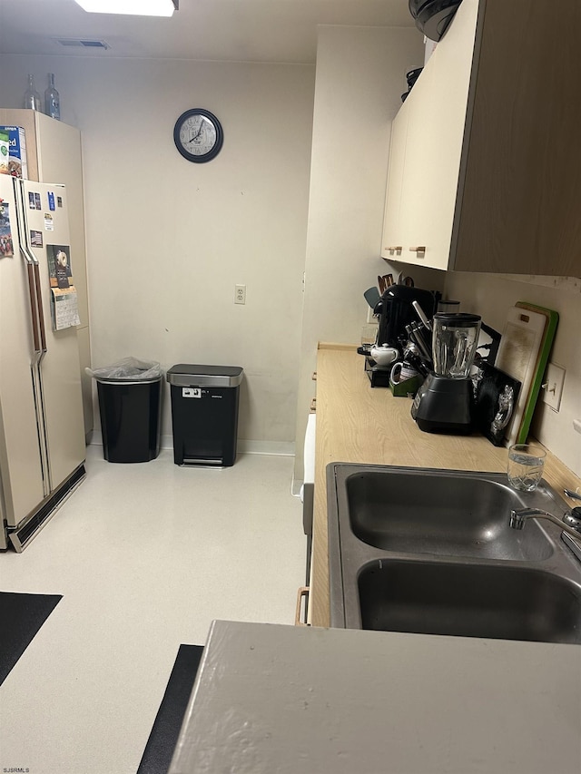 550 Central Ave Unit C4, Linwood, NJ 08221 - kitchen featuring freestanding refrigerator, a sink, baseboards, and light countertops