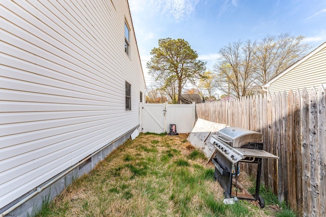 view of yard featuring a gate and a fenced backyard