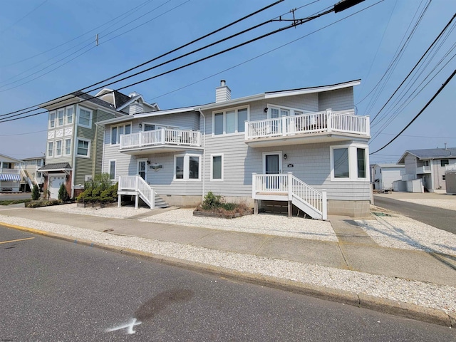 305 57th St Unit 305, Ocean City, NJ 08226 - view of property with a chimney and a balcony