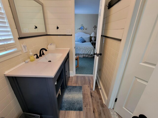 305 57th St Unit 305, Ocean City, NJ 08226 - bathroom featuring vanity, tile walls, wood finished floors, and ensuite bathroom