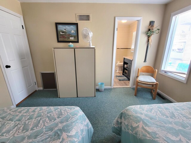 305 57th St Unit 305, Ocean City, NJ 08226 - carpeted bedroom featuring baseboards, visible vents, and ensuite bathroom