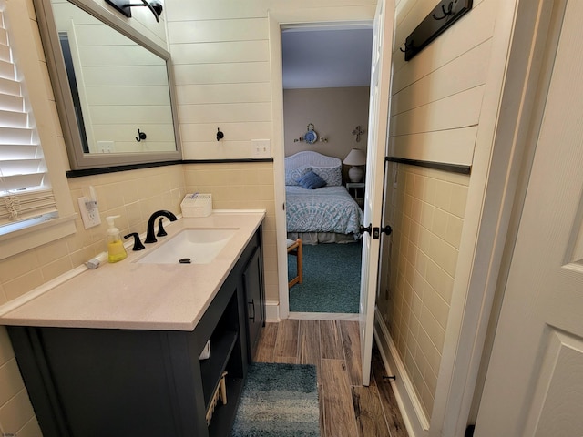 305 57th St Unit 305, Ocean City, NJ 08226 - ensuite bathroom with vanity, tile walls, wood finished floors, and ensuite bath