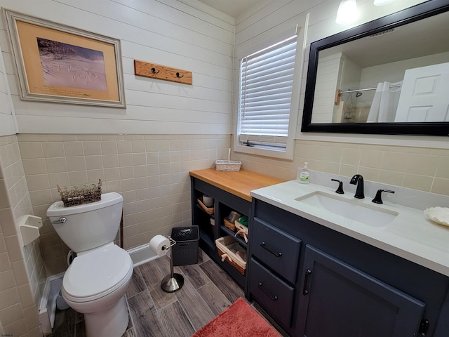 305 57th St Unit 305, Ocean City, NJ 08226 - bathroom with wood finished floors, tile walls, toilet, vanity, and a shower
