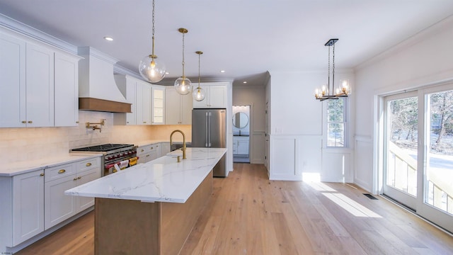 1535 Bear Branch Ct, Vineland, NJ 08362 - kitchen featuring a chandelier, light wood-type flooring, high quality appliances, premium range hood, and wainscoting