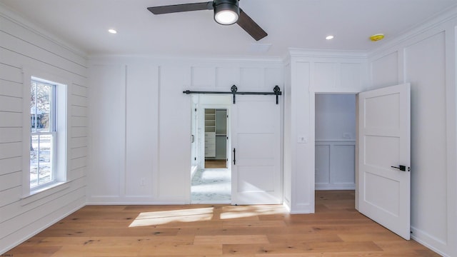 1535 Bear Branch Ct, Vineland, NJ 08362 - unfurnished bedroom featuring multiple windows, a decorative wall, and light wood-style floors