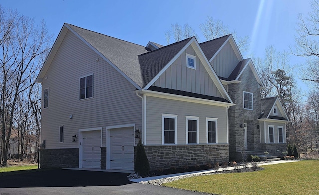 1535 Bear Branch Ct, Vineland, NJ 08362 - view of home's exterior with board and batten siding, a garage, driveway, stone siding, and a lawn