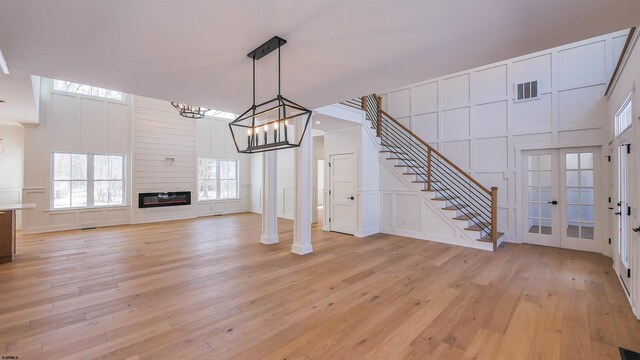 1535 Bear Branch Ct, Vineland, NJ 08362 - unfurnished living room featuring light wood finished floors, stairs, visible vents, and a decorative wall