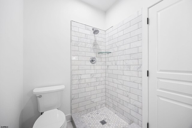 bathroom with toilet and a shower stall