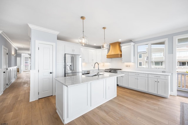 kitchen featuring custom exhaust hood, ornamental molding, a sink, white cabinetry, and stainless steel refrigerator with ice dispenser