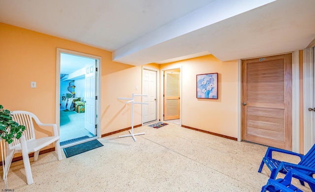 interior space featuring speckled floor and baseboards
