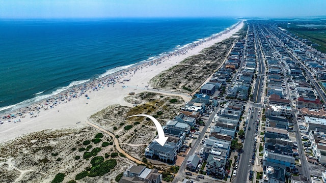 birds eye view of property featuring a water view and a view of the beach
