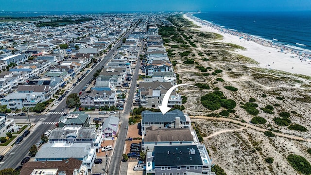 bird's eye view featuring a view of the beach and a water view